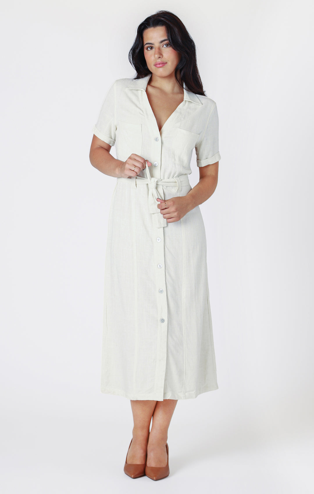 midi-length dress, dress in cream is cinched at the waist with a matching belt, accentuating the silhouette, full button front 