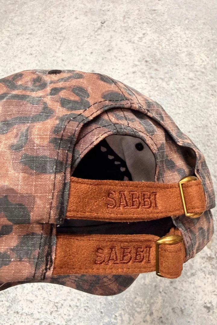 SABBI THE WHO THE BUCK CARES CAP