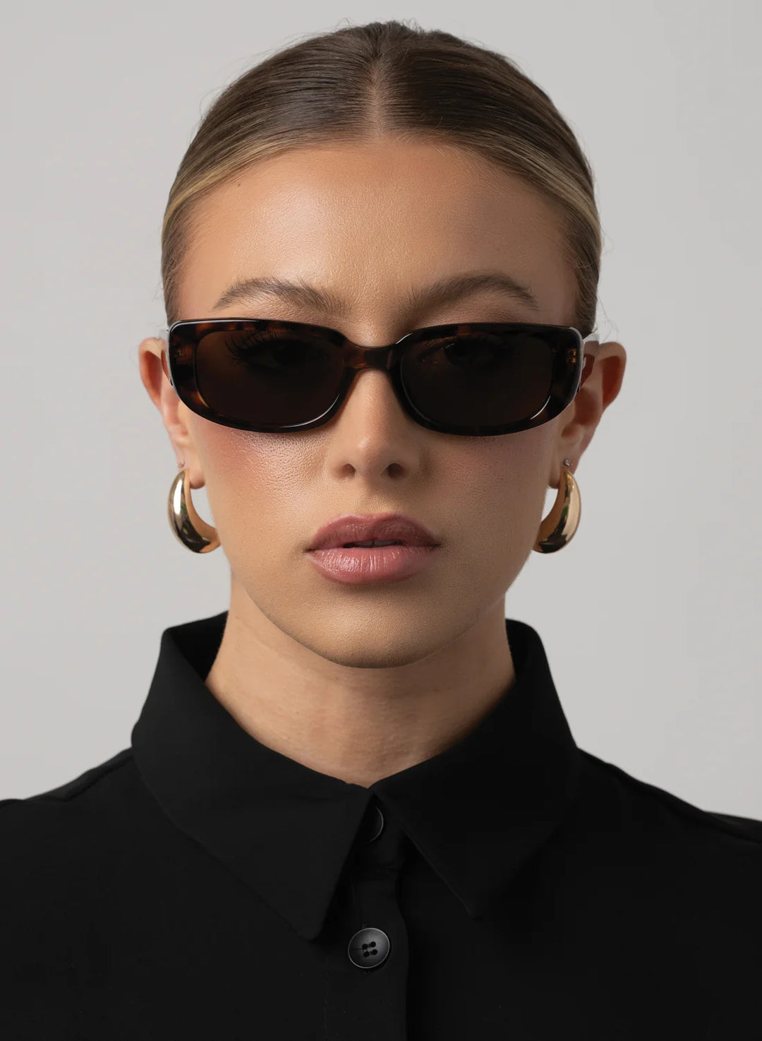 rectangular tortoiseshell with slight cat eye and brown lens 