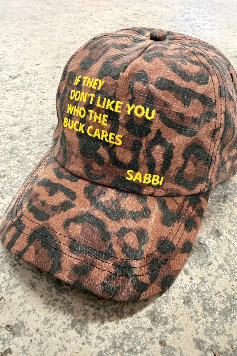 SABBI THE WHO THE BUCK CARES CAP